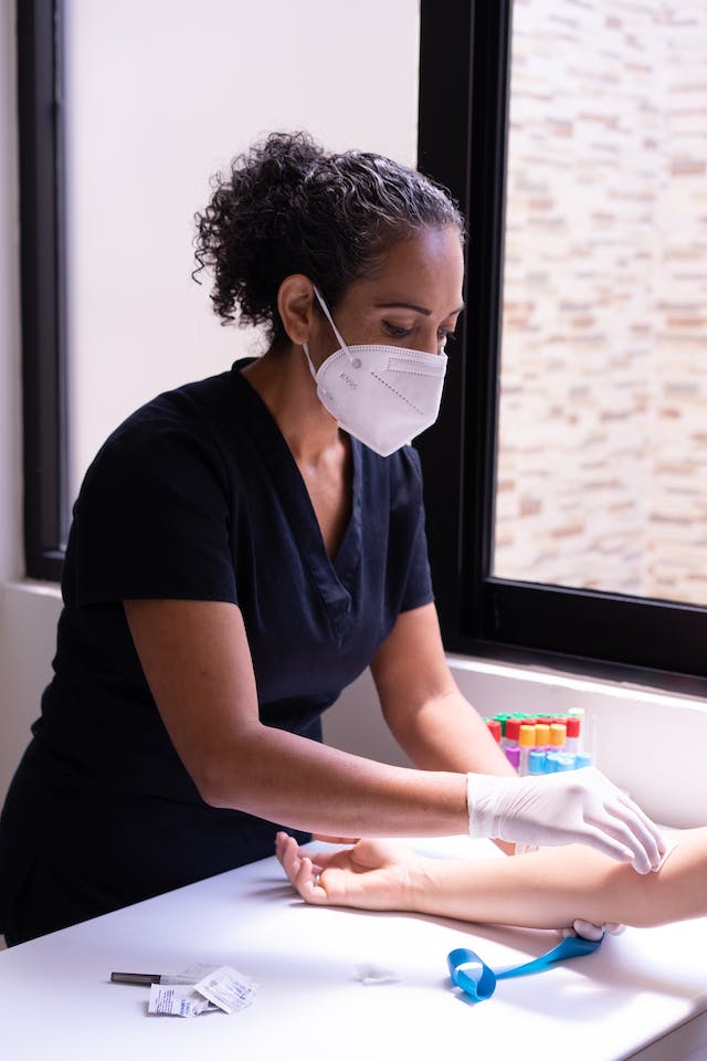 Medical assistant working on a patient